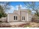 Spacious backyard with concrete patio, mature trees, and rock and mulch landscaping at 2275 S Yosemite Cir, Denver, CO 80231