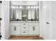 Beautiful bathroom with double sink vanity, modern mirrors and green tile at 2275 S Yosemite Cir, Denver, CO 80231
