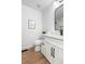 Modern bathroom with stylish vanity, sleek fixtures, and beautiful wood-look floor at 2275 S Yosemite Cir, Denver, CO 80231