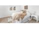 Bright bedroom features a comfortable bed with stylish throw blanket and pillows, and a sunlit window at 2275 S Yosemite Cir, Denver, CO 80231