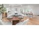 Open-concept layout showcases dining area, kitchen, and living room with wood floors at 2275 S Yosemite Cir, Denver, CO 80231