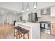 Modern kitchen features stainless steel appliances, a center island with barstool seating, and an open layout at 2275 S Yosemite Cir, Denver, CO 80231