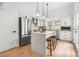 Bright kitchen boasts a center island with seating, stainless steel appliances, and ample cabinet space at 2275 S Yosemite Cir, Denver, CO 80231