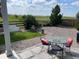 Cozy back yard patio with outdoor dining set, gravel, landscaping, and lush green lawn at 11023 Pastel Pt, Parker, CO 80134