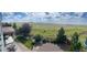 Expansive back yard with mature landscaping, gravel, lush green lawn, fence, and mountain view at 11023 Pastel Pt, Parker, CO 80134
