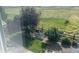 Back yard view features lawn, mature trees, landscaping, gravel, and mountain backdrop at 11023 Pastel Pt, Parker, CO 80134