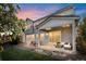 Cozy backyard patio with comfortable seating, a grill, and a well-manicured lawn, perfect for outdoor relaxation and entertainment at 11023 Pastel Pt, Parker, CO 80134