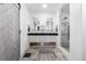 Bright bathroom featuring wood-look tile floors, a modern vanity with double sinks, and a glass-enclosed shower at 11023 Pastel Pt, Parker, CO 80134