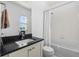 Bright bathroom featuring a white shower curtain, a black countertop, and a mirror for getting ready in the morning at 11023 Pastel Pt, Parker, CO 80134