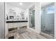 This bathroom features wood look tile floors, a double sink vanity, and a frameless glass shower with unique tile at 11023 Pastel Pt, Parker, CO 80134