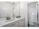 Well-lit bathroom featuring a double sink vanity with white countertops and a separate room with a bathtub at 11023 Pastel Pt, Parker, CO 80134