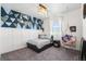 Stylish bedroom featuring blue accent wall with geometric pattern, cozy bed, and hanging pod chair near the window at 11023 Pastel Pt, Parker, CO 80134