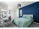 This bedroom features a blue accent wall and large white sliding closet doors at 11023 Pastel Pt, Parker, CO 80134