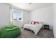 Cozy bedroom featuring a large window, a comfortable bed with plush pillows, and a beanbag chair at 11023 Pastel Pt, Parker, CO 80134