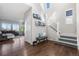 Inviting entryway with hardwood floors, staircase, and comfortable bench at 11023 Pastel Pt, Parker, CO 80134