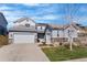 Inviting two-story home with a three-car garage, complemented by a beautifully landscaped front yard and a charming entrance at 11023 Pastel Pt, Parker, CO 80134