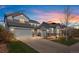 Charming two-story home with a three-car garage and well-maintained landscaping, creating a welcoming curb appeal at 11023 Pastel Pt, Parker, CO 80134