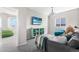 Inviting living room with comfortable seating, modern lighting, a colorful bookshelf, and a wall-mounted TV at 11023 Pastel Pt, Parker, CO 80134