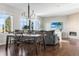 Open living and dining area with large windows, providing natural light and a cozy fireplace at 11023 Pastel Pt, Parker, CO 80134