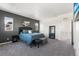 Comfortable main bedroom featuring carpet, gray accent wall, and plenty of natural light from multiple windows at 11023 Pastel Pt, Parker, CO 80134