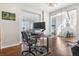 Bright office featuring a modern desk, ergonomic chair, and glass walls for an open feel at 11023 Pastel Pt, Parker, CO 80134