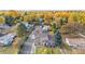 Stunning aerial view of the property nestled amongst colorful foliage in a serene, suburban neighborhood at 1945 Yarrow St, Lakewood, CO 80214
