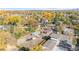 Aerial view showcases property's spacious lot, multiple structures, and proximity to lush greenery at 1945 Yarrow St, Lakewood, CO 80214