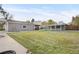 Spacious backyard featuring a well-maintained lawn, covered structures, and convenient detached garage at 1945 Yarrow St, Lakewood, CO 80214