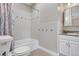 Clean bathroom featuring a tiled shower and tub with a coordinated vanity and sink at 1945 Yarrow St, Lakewood, CO 80214