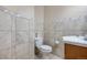 Tiled powder room featuring a granite countertop, a ceramic sink and neutral-colored walls at 1945 Yarrow St, Lakewood, CO 80214