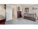 Comfortable bedroom features carpet, a wooden bed frame and a view to an adjoining bathroom at 1945 Yarrow St, Lakewood, CO 80214