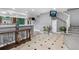 Open concept entryway with tile flooring, an entertainment center, and access to the stairs at 1945 Yarrow St, Lakewood, CO 80214