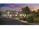Beautiful home exterior with custom stone accents, a new roof, tasteful landscaping, and an attached garage at 1945 Yarrow St, Lakewood, CO 80214