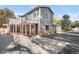 Charming two-story home with gray siding, white trim, and a covered porch at 1945 Yarrow St, Lakewood, CO 80214