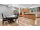 Bright kitchen with hardwood floors, an island with a gas cooktop, and a separate dining area at 1945 Yarrow St, Lakewood, CO 80214