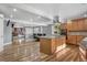 Open concept kitchen and dining area with hardwood floors and barstool seating at 1945 Yarrow St, Lakewood, CO 80214