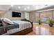 This bedroom features hardwood floors, neutral colors, and a large bay window at 1945 Yarrow St, Lakewood, CO 80214