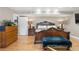 This main bedroom features hardwood floors, a large bed, and elegant furnishings at 1945 Yarrow St, Lakewood, CO 80214