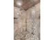 This shower features stone tile, multiple shower heads, and a pebble floor at 1945 Yarrow St, Lakewood, CO 80214