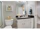 Charming bathroom featuring a well-lit mirror, vanity, and toilet at 4720 S Bannock St, Englewood, CO 80110