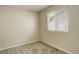 This neutral bedroom features a large window and plush gray carpet at 4720 S Bannock St, Englewood, CO 80110