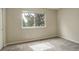 Neutral bedroom features a large window and plush gray carpet at 4720 S Bannock St, Englewood, CO 80110
