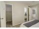 Spacious bedroom with closet, bathroom access, and neutral carpeting at 4720 S Bannock St, Englewood, CO 80110