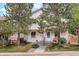 Inviting exterior view of a two-story home with a well-manicured lawn and mature trees at 4720 S Bannock St, Englewood, CO 80110