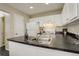 Bright kitchen features white cabinetry, sleek countertops, and modern appliances at 4720 S Bannock St, Englewood, CO 80110