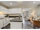 Well-appointed kitchen seamlessly connects to a sunlit dining and living area at 4720 S Bannock St, Englewood, CO 80110