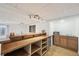 Basement bar area features natural wood countertop, mini fridge, and a sink at 591 Rio Rancho Way, Brighton, CO 80601