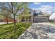 Charming two-story home with a covered front porch, well-manicured lawn and a two-car garage at 591 Rio Rancho Way, Brighton, CO 80601