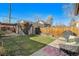 Large backyard with patio, grass, storage shed, and grill at 3403 N Raleigh St, Denver, CO 80212