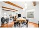 Open concept dining area with hardwood floors and exposed beams at 3403 N Raleigh St, Denver, CO 80212